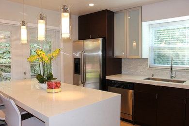 Example of a minimalist kitchen design in Miami with an undermount sink, flat-panel cabinets, dark wood cabinets, quartz countertops, white backsplash, glass tile backsplash, stainless steel appliances and an island