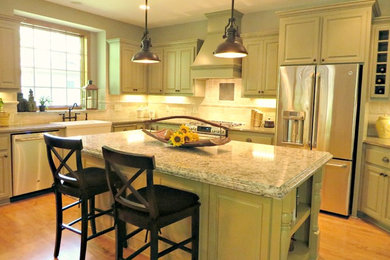 Example of a mid-sized classic light wood floor eat-in kitchen design in Minneapolis with a farmhouse sink, raised-panel cabinets, beige cabinets, beige backsplash, stone slab backsplash, stainless steel appliances and an island