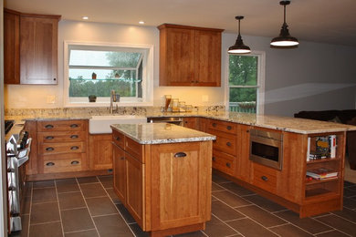 Inspiration for a cottage u-shaped kitchen remodel in DC Metro with a farmhouse sink, granite countertops and an island