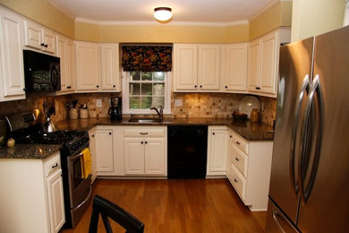 Example of a mid-sized classic u-shaped light wood floor eat-in kitchen design in DC Metro with a drop-in sink, raised-panel cabinets, white cabinets, granite countertops, multicolored backsplash, ceramic backsplash, stainless steel appliances and no island