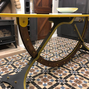 Large contemporary galley open plan kitchen in Other with an integrated sink, solid surface benchtops, yellow splashback, panelled appliances, ceramic floors, with island, multi-coloured floor and yellow benchtop.