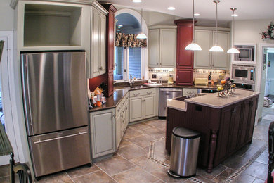 Inspiration for a mid-sized timeless l-shaped ceramic tile eat-in kitchen remodel in St Louis with a double-bowl sink, raised-panel cabinets, white cabinets, quartz countertops, beige backsplash, ceramic backsplash, stainless steel appliances and an island