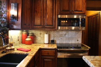 Kitchen - traditional kitchen idea in Oklahoma City with granite countertops and an island