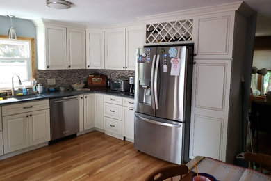 Inspiration for a mid-sized u-shaped eat-in kitchen remodel in Other with white cabinets, no island and blue countertops