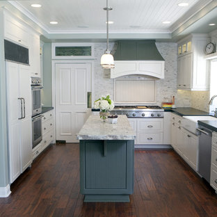 Elegant kitchen photo in Orange County with a farmhouse sink and paneled appliances