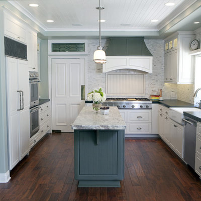 Elegant kitchen photo in Orange County with a farmhouse sink and paneled appliances