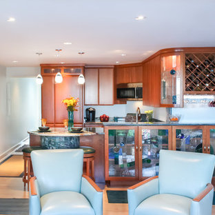 Traditional eat-in kitchen inspiration - Eat-in kitchen - traditional u-shaped eat-in kitchen idea in Boston with an undermount sink, flat-panel cabinets, medium tone wood cabinets, granite countertops, blue backsplash and paneled appliances