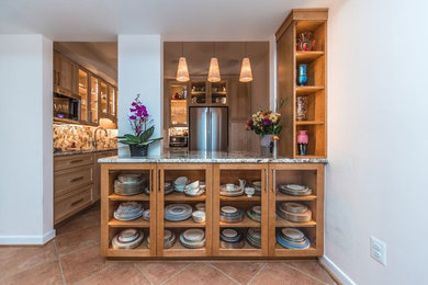 Kitchen - traditional terra-cotta tile kitchen idea in DC Metro with a single-bowl sink, shaker cabinets, light wood cabinets, granite countertops, stone slab backsplash, stainless steel appliances and a peninsula