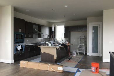 Inspiration for a mid-sized timeless kitchen remodel in Seattle with flat-panel cabinets and an island