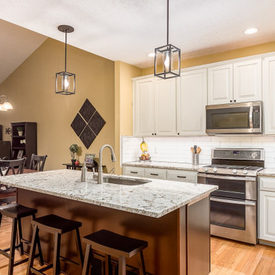 Mid-sized transitional l-shaped eat-in kitchen photo in Columbus with granite countertops and an island