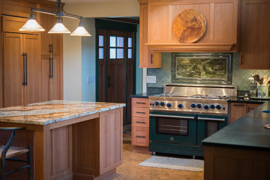 Inspiration for a mid-sized craftsman u-shaped porcelain tile enclosed kitchen remodel in New York with green backsplash, ceramic backsplash, an undermount sink, light wood cabinets, stainless steel appliances and an island