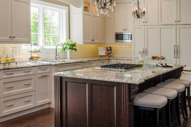 Enclosed kitchen - mid-sized traditional l-shaped dark wood floor enclosed kitchen idea in Chicago with an undermount sink, recessed-panel cabinets, granite countertops, ceramic backsplash, an island, white cabinets, white backsplash and paneled appliances