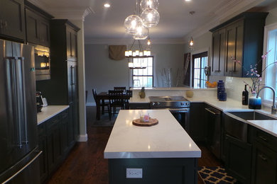 Example of a mid-sized trendy l-shaped dark wood floor eat-in kitchen design in New York with shaker cabinets, dark wood cabinets, quartz countertops, white backsplash, subway tile backsplash, stainless steel appliances, an island and a farmhouse sink
