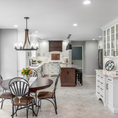 Example of a kitchen design in DC Metro with white backsplash, subway tile backsplash and an island