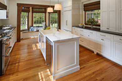 Inspiration for a mid-sized craftsman galley medium tone wood floor kitchen remodel in Indianapolis with a farmhouse sink, beaded inset cabinets, white cabinets and quartz countertops