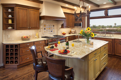 Inspiration for a large southwestern u-shaped dark wood floor and brown floor eat-in kitchen remodel in San Diego with a double-bowl sink, raised-panel cabinets, dark wood cabinets, granite countertops, beige backsplash, ceramic backsplash, stainless steel appliances and an island