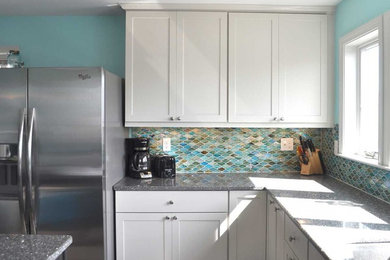 Photo of a contemporary kitchen in Boston with raised-panel cabinets, white cabinets, granite worktops, blue splashback, stainless steel appliances and an island.