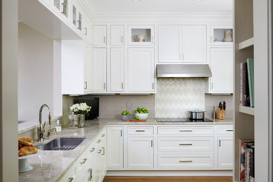 Eat-in kitchen - mid-sized transitional l-shaped medium tone wood floor eat-in kitchen idea in DC Metro with white cabinets, beige backsplash, subway tile backsplash and stainless steel appliances