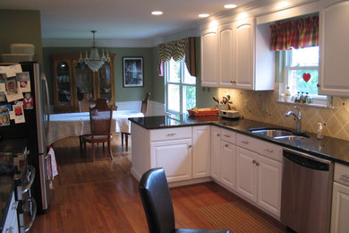 Example of a mid-sized classic galley medium tone wood floor eat-in kitchen design in Cincinnati with an undermount sink, raised-panel cabinets, white cabinets, laminate countertops, beige backsplash, ceramic backsplash, stainless steel appliances and a peninsula