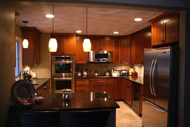 Kitchen photo in Providence with medium tone wood cabinets and stainless steel appliances
