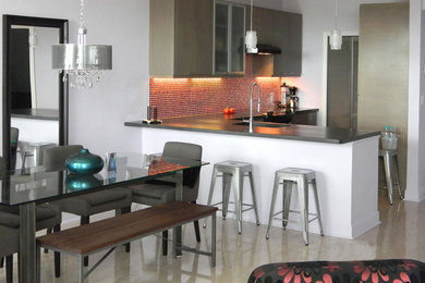 Eat-in kitchen - large modern l-shaped cork floor eat-in kitchen idea in Miami with an undermount sink, flat-panel cabinets, gray cabinets, concrete countertops, red backsplash, glass tile backsplash, stainless steel appliances and a peninsula