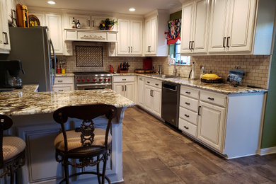 Inspiration for a mid-sized timeless u-shaped ceramic tile and brown floor eat-in kitchen remodel in Dallas with raised-panel cabinets, white cabinets, granite countertops, beige backsplash, ceramic backsplash, stainless steel appliances, no island, multicolored countertops and a drop-in sink