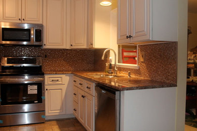 Example of a classic single-wall eat-in kitchen design in Philadelphia with an undermount sink, beaded inset cabinets, distressed cabinets, granite countertops, multicolored backsplash, mosaic tile backsplash and stainless steel appliances