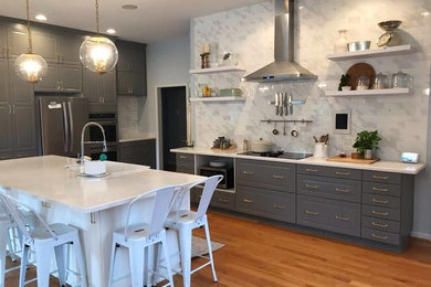 Example of a huge transitional kitchen design in Wilmington with a farmhouse sink, marble backsplash, stainless steel appliances and an island