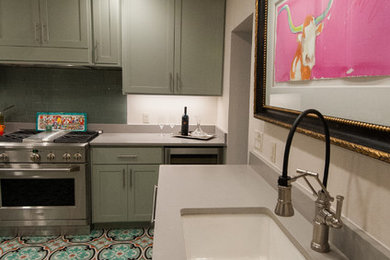 Mid-sized southwest cement tile floor kitchen photo in Austin with an undermount sink, shaker cabinets, green cabinets, quartz countertops, green backsplash, glass tile backsplash and stainless steel appliances