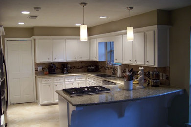 Mid-sized elegant u-shaped ceramic tile and beige floor eat-in kitchen photo in Houston with an undermount sink, recessed-panel cabinets, white cabinets, granite countertops, beige backsplash, ceramic backsplash and stainless steel appliances