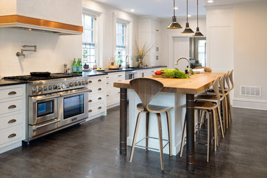 Mid-sized urban galley porcelain tile and brown floor eat-in kitchen photo in Other with an undermount sink, shaker cabinets, white cabinets, soapstone countertops, white backsplash, subway tile backsplash, stainless steel appliances and an island