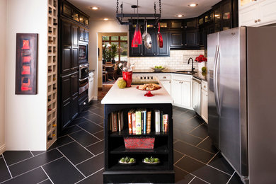 Inspiration for a mid-sized transitional u-shaped porcelain tile eat-in kitchen remodel in Other with a double-bowl sink, raised-panel cabinets, dark wood cabinets, granite countertops, metallic backsplash, glass tile backsplash, stainless steel appliances and an island