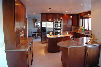 Example of a mid-sized classic u-shaped beige floor and light wood floor open concept kitchen design in Other with a double-bowl sink, beige backsplash, porcelain backsplash, stainless steel appliances, an island, raised-panel cabinets, light wood cabinets and quartz countertops
