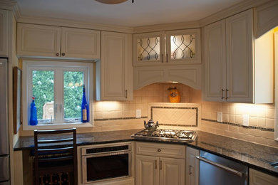 Example of a transitional kitchen design in New York with raised-panel cabinets, light wood cabinets, beige backsplash, ceramic backsplash and stainless steel appliances