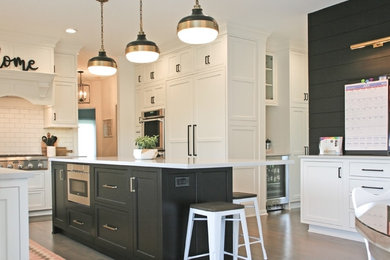 Large l-shaped medium tone wood floor and gray floor eat-in kitchen photo in Chicago with an undermount sink, beaded inset cabinets, white cabinets, quartz countertops, white backsplash, subway tile backsplash, paneled appliances, an island and gray countertops