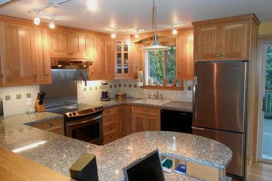 Mid-sized arts and crafts u-shaped bamboo floor eat-in kitchen photo in Seattle with a single-bowl sink, shaker cabinets, light wood cabinets, granite countertops, porcelain backsplash and stainless steel appliances