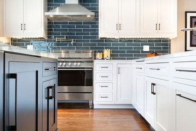 Inspiration for a mid-sized transitional u-shaped medium tone wood floor open concept kitchen remodel in New York with an undermount sink, shaker cabinets, white cabinets, marble countertops, blue backsplash, porcelain backsplash, stainless steel appliances and an island