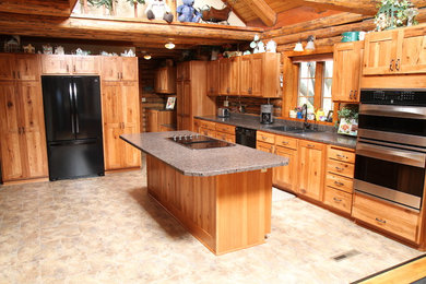 Mountain style l-shaped eat-in kitchen photo in Other with a double-bowl sink, light wood cabinets and an island