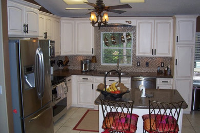 Small trendy l-shaped beige floor eat-in kitchen photo in Tampa with a double-bowl sink, raised-panel cabinets, white cabinets, mosaic tile backsplash, stainless steel appliances, an island, granite countertops and multicolored backsplash