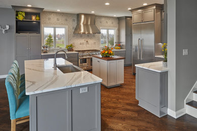 Kitchen - transitional kitchen idea in Indianapolis with shaker cabinets, gray cabinets, quartz countertops, porcelain backsplash and two islands