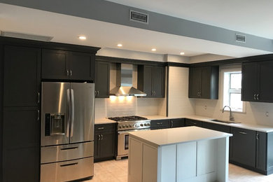 Mid-sized minimalist l-shaped ceramic tile and beige floor eat-in kitchen photo in New York with an undermount sink, shaker cabinets, gray cabinets, quartzite countertops, white backsplash, porcelain backsplash, stainless steel appliances, an island and white countertops