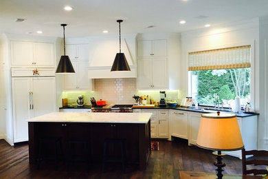 Example of a huge transitional single-wall medium tone wood floor eat-in kitchen design in Houston with an undermount sink, shaker cabinets, white cabinets, marble countertops, white backsplash, subway tile backsplash, white appliances and an island