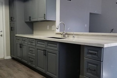 Inspiration for a small transitional galley gray floor enclosed kitchen remodel in Houston with an undermount sink, raised-panel cabinets, gray cabinets, quartzite countertops, no island and white countertops