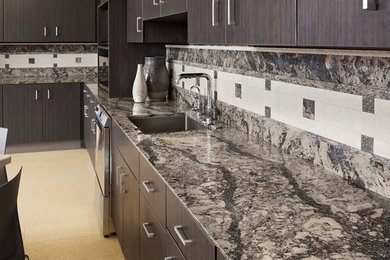 Mid-sized trendy l-shaped ceramic tile and beige floor eat-in kitchen photo in Milwaukee with an undermount sink, flat-panel cabinets, dark wood cabinets, quartz countertops, multicolored backsplash, stone tile backsplash, stainless steel appliances and black countertops