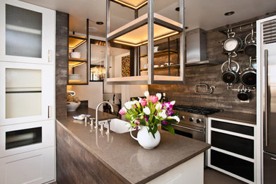 Open concept kitchen - mid-sized transitional galley open concept kitchen idea in Toronto with a farmhouse sink, glass-front cabinets, white cabinets, concrete countertops, gray backsplash, porcelain backsplash, stainless steel appliances and a peninsula