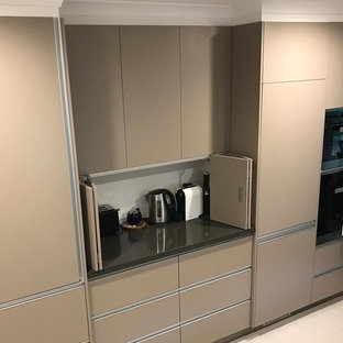 Design ideas for a mid-sized modern u-shaped separate kitchen in Canberra - Queanbeyan with a double-bowl sink, flat-panel cabinets, beige cabinets, quartz benchtops, blue splashback, ceramic splashback, panelled appliances, ceramic floors, yellow floor and orange benchtop.