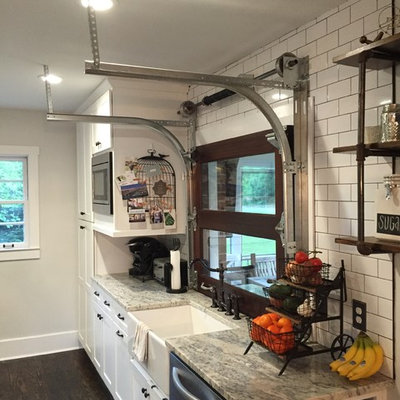 Inspiration for a mid-sized farmhouse galley dark wood floor eat-in kitchen remodel in Atlanta with a farmhouse sink, shaker cabinets, white cabinets, granite countertops, white backsplash, subway tile backsplash, stainless steel appliances and no island