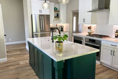 Inspiration for a mid-sized transitional multicolored floor kitchen remodel in San Diego with a farmhouse sink, shaker cabinets, white cabinets, quartzite countertops, white backsplash, subway tile backsplash, stainless steel appliances, two islands and white countertops