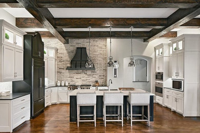 Inspiration for a large cottage l-shaped dark wood floor and brown floor open concept kitchen remodel in Los Angeles with a double-bowl sink, shaker cabinets, white cabinets, solid surface countertops, beige backsplash, brick backsplash, colored appliances, an island and brown countertops