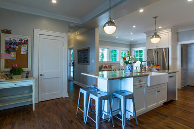 Example of a transitional kitchen design in Tampa with a farmhouse sink, granite countertops, ceramic backsplash and stainless steel appliances